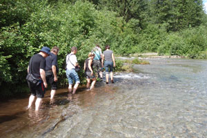 Enjoy sockeye salmon cooked over an open fire by the Exchamsiks River